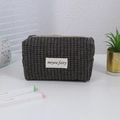 Detail of retro houndstooth makeup bag with metal zipper and minimalist fabric label - Dark Grey Plaid