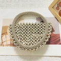 Handcrafted silver beaded semi-round handbag with metallic finish and circular top handle - Silver