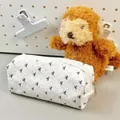 White canvas stationery pouch with black bow prints and silver zipper closure - Bow