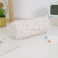 Close-up of white plush pencil case with colorful speckles on a cozy desk setup - White