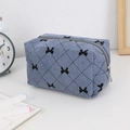 Detail of blue corduroy makeup bag with bow embroidery and quilted rhombus pattern - Blue Bow