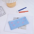 Astuccio in tela blu con ricamo a fiocco rosa su scrivania bianca con accessori - Blu