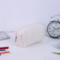 Detail of white plush pencil case with zipper and soft faux fur texture for students - White