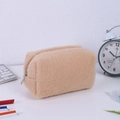 Close-up of a plush khaki storage bag on a desk with stationery items and keyboard - Khaki