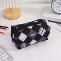 Close-up of quilted floral pencil case with cartoon bear and smooth metal zipper - Black
