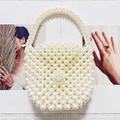 Elegant handmade cream pearl beaded handbag featuring floral accents and a round handle - White