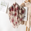 Detail of floral printed pleated scarf with elegant texture hanging on a wooden rack - 80*80cm / Red