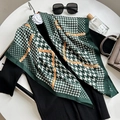 Elegant green houndstooth silk scarf styled with fashion accessories on a white table - Dark Green