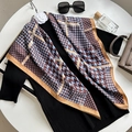 Elegant silk-like houndstooth scarf in blue and brown styled on a table with accessories - Sky Blue