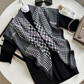Elegant green houndstooth silk scarf with purple accents styled on a black sweater - Black & White