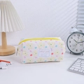 Detail of quilted floral pencil case with yellow zipper and sweet girl label - Yellow