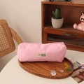 Close-up of pink corduroy pencil case with Colorful Fantasy label on a wooden tray - Pink