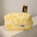 Detail of plush yellow makeup bag with 3D embossed hearts and soft furry texture - Yellow