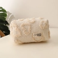 Detail of plush heart makeup bag featuring soft lamb wool texture and cute bear logo tag - Off White
