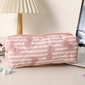 Close-up of quilted pink stripe pencil case with purple bow pattern and metal zipper - Striped Bow