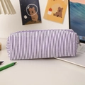 Detail of purple striped seersucker pencil case showing fabric texture and sturdy zipper - Purple Striped