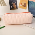 Close-up of seersucker pencil case with orange stripes and high-capacity storage - Orange Stripes
