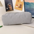 Seersucker striped pencil case on a desk with a laptop and cartoon art background - Black & White Stripes