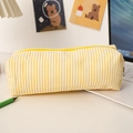 Detail of yellow seersucker pencil case with zipper closure on office desk setting - Yellow Plaid