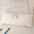 Detail of white jacquard pencil case with textured rhombus pattern and colorful woven bow - White