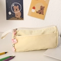 Detail of yellow canvas pencil pouch with pink cloud charm and front storage pocket - Yellow