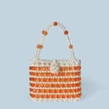 Detailed view of handmade beaded handbag with white pearls and orange crystal accents - Orange