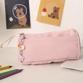 Pink canvas pencil case with cute star and sheep charms on a white desk with pencils - Pink