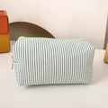 Detail of green and white striped canvas pencil case with a bright green zipper closure - Green