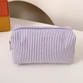 Detail of purple and white striped pencil case showing textured fabric and zipper - Purple