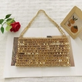 Close-up of golden beaded handbag with metallic scale texture and hand-woven design - Gold
