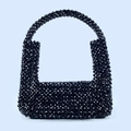 Close-up of handmade black beaded handbag featuring shiny faceted beads and integrated handle - Black