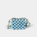 Detailed view of light blue handmade beaded mini bag with gold accent beads and clasp - Blue