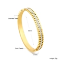 Detail of 18K gold plated stainless steel geometric bangle with inlaid sparkling crystals - Gold Toothed Pave Zirconia Style (BR925402G)
