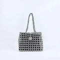 Macro shot of silver hollowed beaded bag with intricate handmade pearl textures - Silver