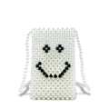White handmade pearl beaded phone bag with black smiley face pattern and long strap - White