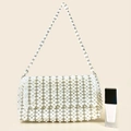 Close-up of hand-woven white pearl shoulder bag with textured beadwork and metal rings - Milky White
