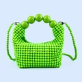Detail view of bright green handmade beaded handbag with large gradient bead handle - Green