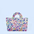 Detailed macro view of colorful handmade beaded handbag with vibrant rainbow pattern beads - Colorful