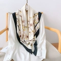 Elegant magnolia print faux silk square scarf with black border on a white blouse - 90cmx90cm / Off-white
