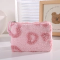 Close-up of pink plush makeup bag with soft lamb wool texture and silver zipper detail - Pink