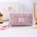 Detail of soft pink leopard plush makeup bag with fabric label and fluffy handle - Pink Leopard
