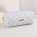 Detail shot of blue gingham quilted pencil case with cherry print and Colorful woven label - Sky Blue