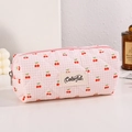 Detail of pink plaid quilted fabric case with cherry prints and zip closure - Pink