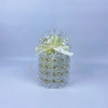 Detailed close-up of handmade beaded handbag with gold accents and cream satin liner - Clear