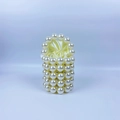 Close-up of pearl beaded handbag featuring gold accents and a satin drawstring liner - Milky White