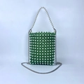 Close-up of green and white handmade beaded bag with pearl handle and silver chain strap - Green