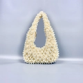 Detailed view of handmade pearl woven baguette bag with golden metal zipper and cream beads - Milky White