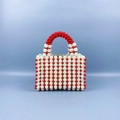 Detail of handmade beaded handbag with red and white resin pearls in retro style - Red