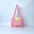 Dettaglio borsa di perline rosa con fiocco di perle e fodera in raso dorato con coulisse - Rosa