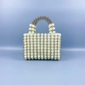 Detail of handmade beaded handbag with white pearls and silver metal texture beads - Silver